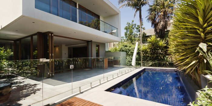 Rear garden of a contemporary Australian home with tiled swimming pool