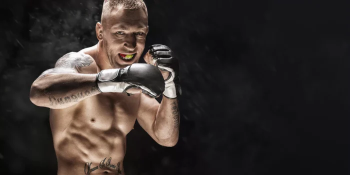 Mixed martial artist posing on a black background. Concept of mma, ufc, thai boxing, classic boxing.