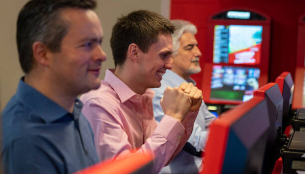 Excited latin american winning a bet at the casino while looking at the screen happy and smiling